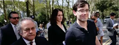  ?? Seth Wenig, AP (Photo by ?? Martin Shkreli, right, and his attorney Benjamin Brafman, left, leave federal court in New York, Friday, Aug. 4, 2017. The former pharmaceut­ical CEO has been convicted on federal charges he deceived investors in a pair of failed hedge funds. A Brooklyn...