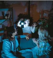  ?? DREAMSTIME ?? Don’t forget to make plans to entertain each other and stave off boredom during extended power outages.