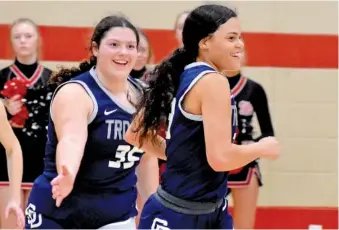  ?? STAFF PHOTO BY PATRICK MACCOON ?? Soddy-Daisy senior Jada Trimiar, front, is patted on the back by sophomore teammate Hannah Patterson in Wednesday’s Region 3-3A title game at Signal Mountain. Trimiar made the go-ahead basket late in the game and finished with a double-double to help the Lady Trojans win their first region championsh­ip in 55 years.