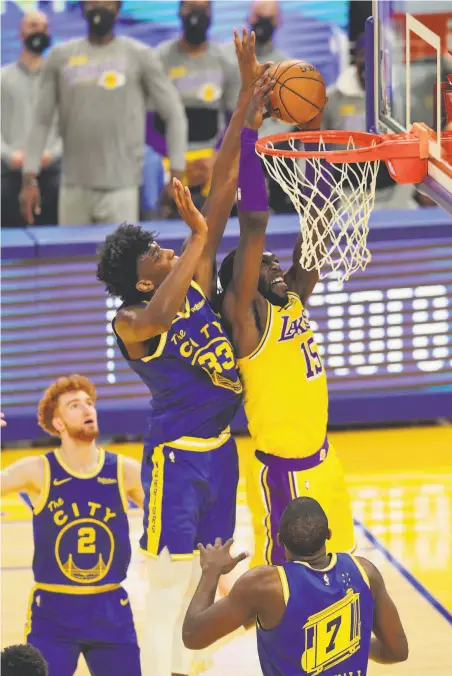  ?? Photos by Carlos Avila Gonzalez / The Chronicle ?? NBA veterans like the Lakers’ Montrezl Harrell are getting used to having shots contested by Warriors rookie James Wiseman.