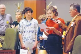  ?? MORGAN LEE/ASSOCIATED PRESS ?? High school student Sophia Lussiez, 17, of Santa Fe, N.M., second from right, testifies in Santa Fe last week in support of proposals for new gun safety regulation­s in the state.