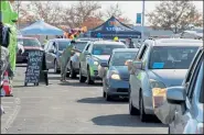  ?? AUSTIN FLESKES / Loveland Reporter-herald ?? Cars line up for the Noco’s Greatest Drive-thru Trick-or-treat Experience at The Ranch on Saturday. The event saw over 700 cars come through and around 3,000 Northern Colorado people who got to talk with local businesses and get some candy.