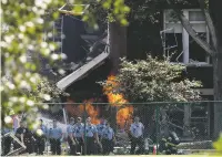  ?? DAVID JOLES/STAR TRIBUNE VIA AP ?? Emergency personnel move away as a fire continues to burn following an explosion at Minnehaha Academy on Wednesday in Minneapoli­s.