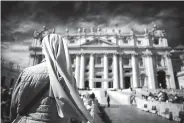  ?? Associated Press ?? ■ A nun waits for the arrival of Pope Francis for his weekly general audience in St. Peter’s Square at the Vatican.