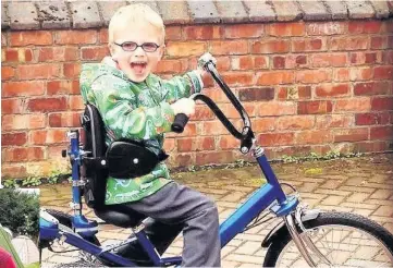  ??  ?? Above, Bertie Kay enjoys a ride on his special trike; left, hangs out with the family and, right, advertises Bertie’s Buccaneers