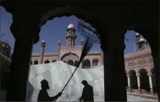  ?? Muhammad Sajjad/Associated Press ?? Volunteers clean the outer areas of the historic Mohabat Khan Mosque ahead of the upcoming Muslim fasting month of Ramadan, in Peshawar, Pakistan, on Friday.