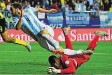  ??  ?? One that got away Argentina forward Gonzalo Higuain leaps over Jamaica goalkeeper Dwayne Miller during their match in Vina del Mar.