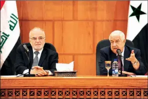  ?? AP/SANA ?? Syrian Foreign Minister Walid al-Moallem (right) and Iraqi counterpar­t Ibrahim al-Jaafari hold a news conference Monday during al-Jaafari’s visit to Damascus. Syria is working to renew ties with its neighbors after removing rebel forces from most of the country.