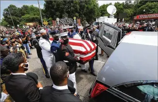  ?? CURTIS COMPTON / CCOMPTON@AJC.COM ?? Members of the U.S. military transfer the body of Rep. John Lewis after his final crossing Sunday of the Edmund Pettus Bridge, site of the 1965 voting rights marches.