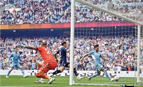  ?? (AFP) ?? Manchester City's German midfielder Ilkay Gundogan scores his team’s third goal during the EPL match against Aston Villa at the Etihad Stadium in Manchester, north west England