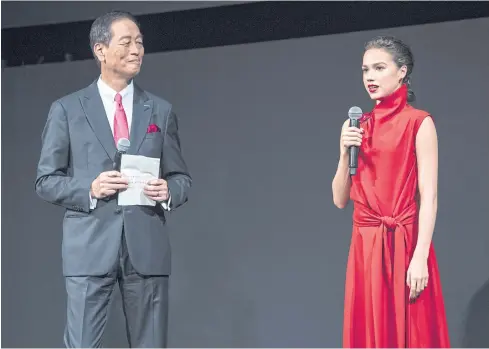 ?? BLOOMBERG ?? Masahiko Uotani, president of Shiseido Co, listens to Alina Zagitova, Russian figure skater and the company’s global ambassador, during a news conference in Tokyo on Wednesday.