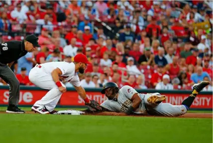  ?? Dilip Vishwanat/Getty Images ?? Josh Bell beats the throw to Matt Carpenter at third base after a wild pitch in the second inning Friday at Busch Stadium in St Louis. After getting a two-game rest, Bell went 2 for 3 with two runs scored.