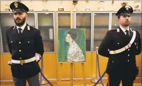  ?? Antonio Calanni / Associated Press ?? Art experts have confirmed that a stolen painting discovered hidden inside an Italian art gallery’s walls is Gustav Klimt’s “Portrait of a Lady.”