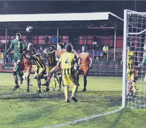  ??  ?? Workington keeper Aaran Taylor shudders the Boro bar with a late header Pictures by Ben Challis and Mike McKenzie