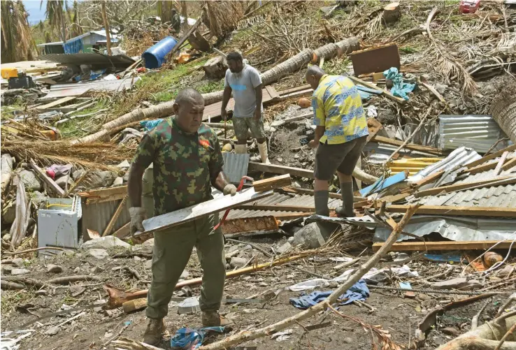  ?? Photo: Laisa Lui ?? Republic of Fiji Military Forces personnel are on the ground on Kia Island helping villagers clear away debris left behind by Cyclone Yasa.