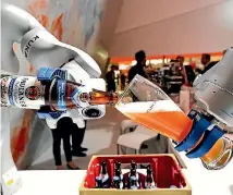  ?? FABIAN BIMMER ?? A robot fills a glass with beer at the booth of German company Kuka at the world’s biggest industrial fair in Hanover, Germany.