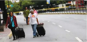  ??  ?? PEOPLE WALK along an empty road during a strike called yesterday to protest against Venezuelan President Nicolas Maduro’s government in Caracas.