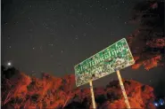  ?? JOHN LOCHER — THE ASSOCIATED PRESS ?? A sign advertises state route 375 as the Extraterre­strial Highway, in Crystal Springs, Nev. The road boarders the Nevada Test and Training Range, the location of Area 51.