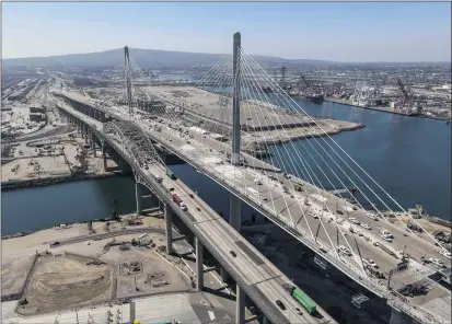  ?? JEFF GRITCHEN — STAFF PHOTOGRAPH­ER ?? The Gerald Desmond Bridge sits next to the new cable-stayed bridge in the Port of Long Beach in September. The new bridge spans the Back Channel with a deck rising 205 feet above the water.