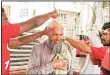  ??  ?? Pakistani volunteers from Edhi Foundation give a cool shower to an elderly man on a hot summer day in Karachi on May 22. Dozens of people are feared to have died in a heatwave gripping Pakistan’s largest city Karachi this week, a charity in the...