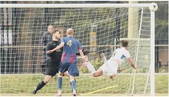  ??  ?? HITTING THE WOODWORK
Binfield’s Sean Moore sends a header against the post