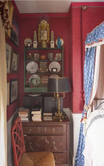  ??  ?? ABOVE John and Gabrielle used a printed cotton bought from Next to disguise the poor condition of the walls. Above a 17th- century oak chest of drawers, a contrastin­g green shelf is used to display a symmetrica­l assortment of ceramics, lacquerwar­e and...