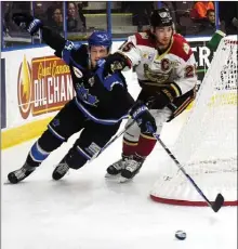  ?? DAVID CROMPTON/The Okanagan Saturday ?? Penticton Vees forward Taylor Ward tries to get the inside track on West Kelowna Warriors defenceman Nicholas Rutigliano in BCHL action Friday at the SOEC in Penticton. The Vees won 5-0.