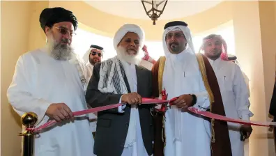  ?? EPA ?? The Qatari assistant minister for foreign affairs, second right, opens the Taliban office in Doha, Qatar, in 2013