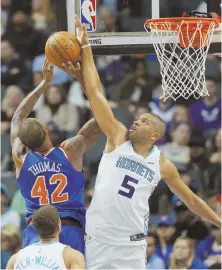  ?? AP PHOTO ?? BAT-MAN: Nicolas Batum blocks a shot by the Knicks’ Lance Thomas during the Hornets’ 109-91 victory last night in Charlotte, N.C.