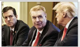  ?? Bloomberg News ?? John Ferriola {middle), president and CEO of Nucor Corp., talks with President Donald Trump during a meeting in the White House in March.