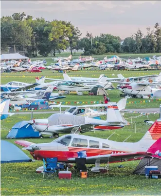  ?? PHOTOS: GEOFF GRENVILLE/ FOR NATIONAL POST ?? Wittman Regional Airport in Oshkosh, Wis., during EAA AirVenture 2015, a weeklong annual aviation celebratio­n which took place in July. A portion of the area is reserved for visitors to the event who camp next to their airplanes.