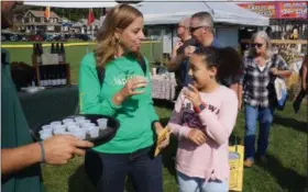  ?? WILLIAM J. KEMBLE PHOTO ?? Kimberly Ludrick, and daughter Jaden, 11, of Newburgh, taste garlic vinegar at the Hudson Valley Garlic festival at Cantine Field in Saugerties on Saturday.