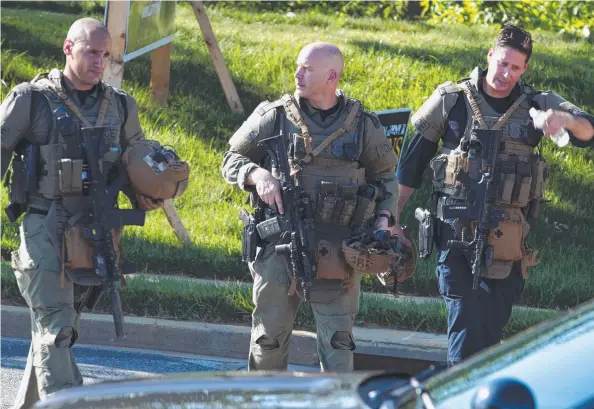  ??  ?? PRESS ATTACK: Maryland police officers at the scene after multiple people were shot at a newspaper office building in Annapolis yesterday, A single shooter allegedly killed several people and wounded others before police arrived and placed a suspect in custody. Picture: AP
