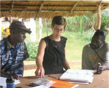  ??  ?? Word perfect ... Kate Lindsey at work on an Ende dictionary with pastor Warama Kurupel and chief Jerry Dareda.
