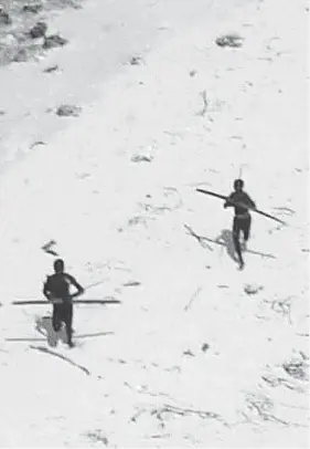  ?? INDIAN COAST GUARD ?? Tribesmen with bows are seen on India’s North Sentinel island, a remote area untouched by modern civilizati­on and off-limits to outside visitors.