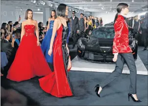  ?? "1 1)050 ?? Models walk the runway in front of Ralph Lauren’s car collection in The Garage at the Ralph Lauren fashion show during Fashion Week, earlier this week in New York.