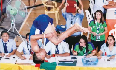  ??  ?? Mark Castelo of Calabarzon performs a routine as judges look on during the secondary boys vault artistic gymnastics of the Palarong Pambansa yesterday at the University of Immaculate Concepcion in Davao City. (Rio Leonelle Deluvio)