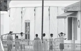  ?? AP/BRYNN ANDERSON/File ?? Immigrant children walk in a line outside the Homestead Temporary Shelter for Unaccompan­ied Children, a former Job Corps site housing them in Homestead, Fla., on June 20.