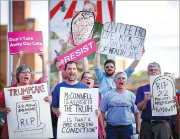  ??  ?? Protesters rally outside a Harden County Republican party fundraiser where McConnell is scheduled to speak in Elizabetht­own, Kentucky. — Reuters photo