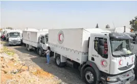  ?? THE ASOCIATED PRESS ?? A convoy of the Syrian Red Crescent vehicles arrives to Douma, eastern Ghouta, a suburb of Damascus, Syria, on Monday. Desperate for food and medicine, Syrian civilians in the war-ravaged eastern suburbs of Damascus hoped for relief Monday as the...