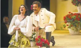  ?? ARIC CRABB/STAFF ?? Rene Barbera, right, as Count Almaviva listens to Daniela Mack as Rosina pour her heart out in a scene from Rossini’s “The Barber of Seville.”