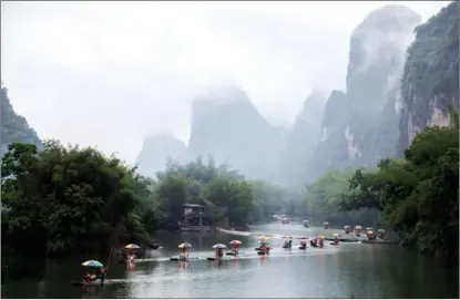  ?? MAO YANZHENG / FOR CHINA DAILY ?? Tourists take a trip on the scenic Lijiang River on bamboo rafts in Guilin, Guangxi Zhuang autonomous region, on April 14.