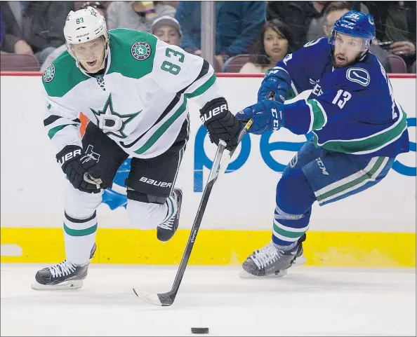  ?? GERRY KAHRMANN/PNG FILES ?? Canucks centre Nick Bonino chases after Ales Hemsky during Vancouver’s 4-3 OT loss to the Dallas Stars Saturday at Rogers Arena. Bonino had a goal and an assist in a five-point night for the second line which has been playing well in recent games.