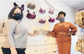  ?? PAM PANCHAK/PITTSBURGH POST-GAZETTE ?? Levana Bratique owner Judy Masucci and store manager Adrian Foy in front of an art display of bras in their store Aug. 24 in Wexford, Pennsylvan­ia.