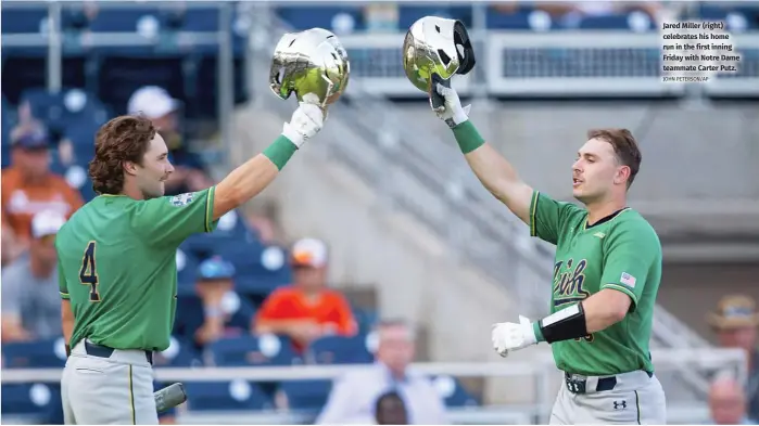  ?? JOHN PETERSON/AP ?? Jared Miller (right) celebrates his home run in the first inning Friday with Notre Dame teammate Carter Putz.