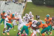  ?? STAFF PHOTO BY AJ MASON ?? Westlake seniors Raeshad Herriott, left, and Pearson Benson tackles McDonough’s Avaughn Holley in Saturday’s SMAC Chesapeake Division football contest. Westlake won 30-0.