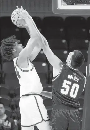  ?? CHARLES REX ARBOGAST AP ?? Florida Atlantic’s Vladislav Goldin blocks the shot of Loyola’s Miles Rubin during the first half Wednesday night. Goldin set a personal best with five blocks in the game.