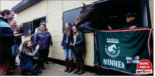  ??  ?? One For Arthur proves a big hit back at his stables in Milnathort after the triumphant race, below, at Saturday’s Grand National