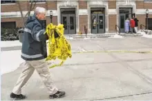  ?? JOHN TERHUNE, THE (LAFAYETTE, IND.) JOURNAL & COURIER ?? Kevin Luse of Purdue University’s fire department collects police tape a day after a student killed a teaching assistant.