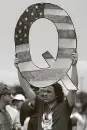  ?? Associated Press file photo ?? A participan­t holds a Q sign at a 2018 Trump campaign rally.